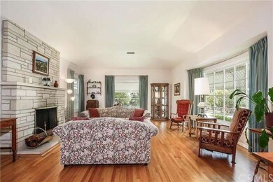 Living Room, Fireplace, Hardwood Floor, Bay Window