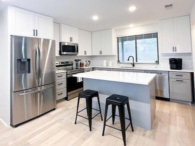 Kitchen with stainless steel appliances, a sink, 