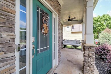 Doorway to property featuring ceiling fan and a porch