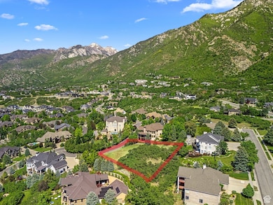 View of property location with a mountainous background, property boundaries highlighted, and nearby suburban area