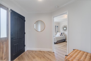 Entrance foyer with light wood-style flooring, or