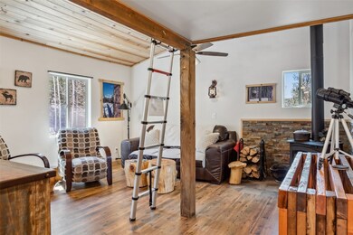 Bedroom featuring beam ceiling, multiple windows,