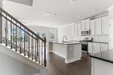 Kitchen with a sink, dark countertops, stainless s