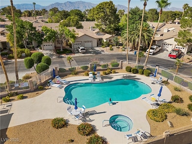 Community pool featuring a mountain view, a hot tu
