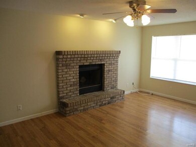 Large Rooms Throughout - Living Room with Woodburning Fireplace and Wood Look Laminate Flooring
