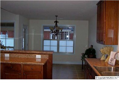 Kitchen Showing Raised Bar and Dining Area, Cabinets have raised panel doors.