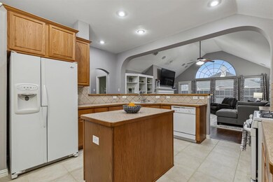 Large open kitchen with island, lots of countertop space and cabinets for stoarge.