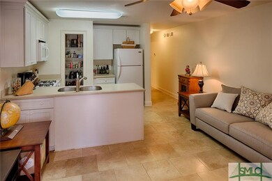 Garden apartment with small kitchen and tile floor