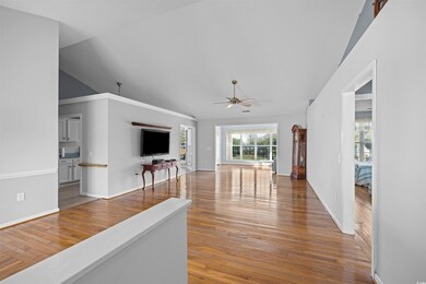 Living room with wood-type flooring, high vaulted 