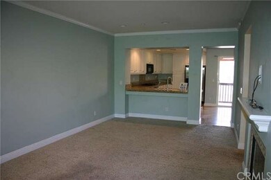Living room has a fireplace, balcony, and built in