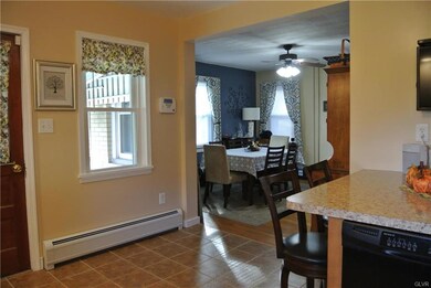 View of the dining room from the kitchen.  Warm ho