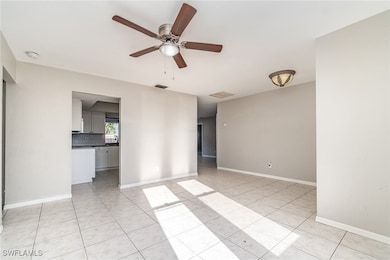 Unfurnished room with light tile patterned floorin