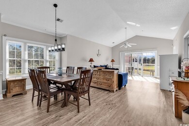 Dining area featuring a textured ceiling, vaulted 