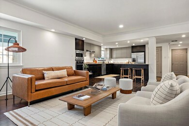 Living room featuring baseboards, recessed lighti
