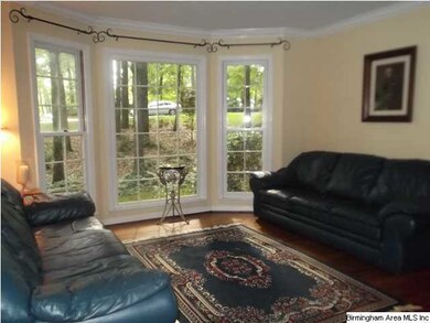 FORMAL LIVING ROOM WITH HARDWOOD FLOORS AND BAY WI