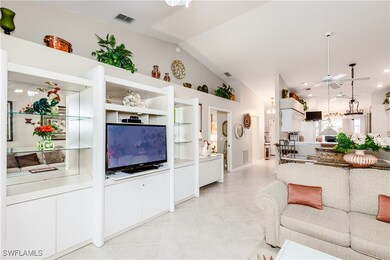 Living area featuring ceiling fan, vaulted ceiling