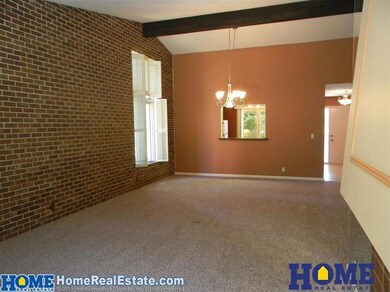 Another view of the living room and informal dining room. This view shows the pass-through into the kitchen.