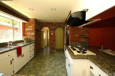 Kitchen has tons of charm.  Nice cabinetry & red b