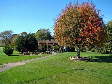 Exterior Back. 3/4 Acre lot is beautifully landsca
