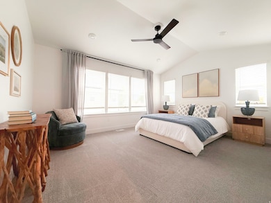 Bedroom featuring vaulted ceiling, carpet, and ceiling fan