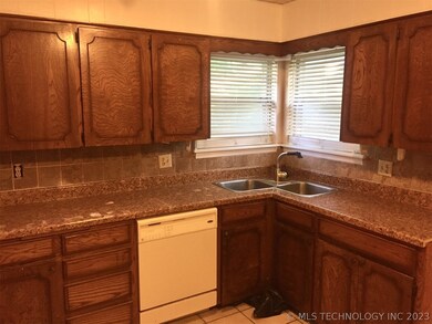 Kitchen with corner sink, to the right is the rang