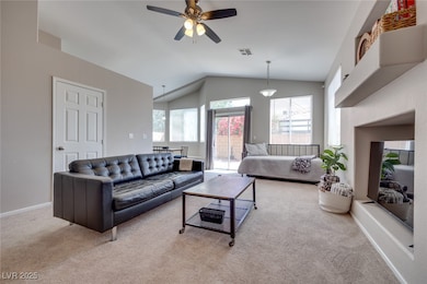 Living room with lofted ceiling, carpet flooring,