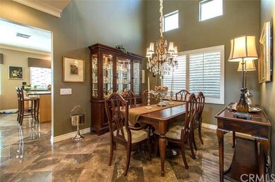 Formal dining has high ceilings & warm earth toned