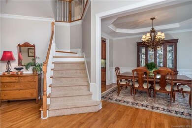Bright 2 Story Foyer Opens to Dining Room with Tre