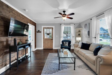 Living room with ceiling fan, dark hardwood / wood