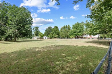 View of yard with a storage unit