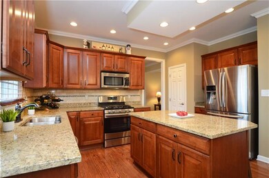 The kitchen offers stainless appliances, crown mol