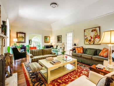 Living area featuring wood finished floors, vault