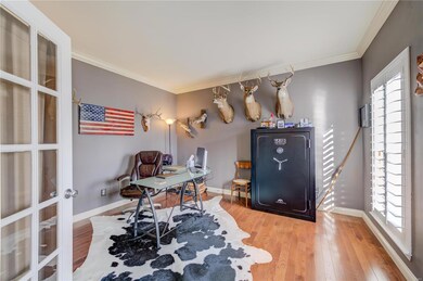 Office with glass French Doors, hardwood floors an