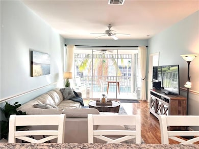 Living room with wood-type flooring and ceiling fa