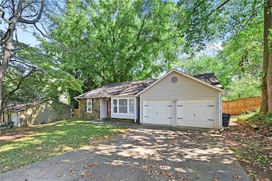 View of front of house featuring concrete driveway and a garage