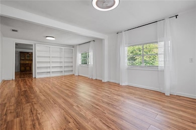 Unfurnished bedroom with wood finished floors