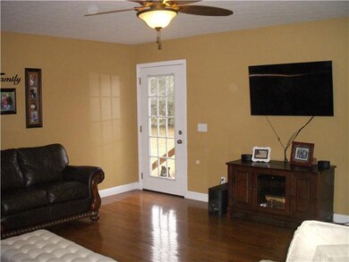Large living room with updated paint colors and hardwood flooring makes this room the heart of the home