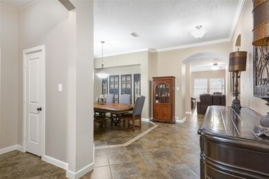 Let's head inside.  The living area is all tile, for easy maintenance, especially with the pool!  To the left is the office and half bath, and past the formal dining is the open family area.