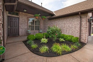 Cozy front porch nicely landscaped with easy to ma