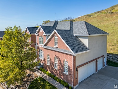 View of side of property with concrete driveway, brick siding, a shingled roof, and a garage