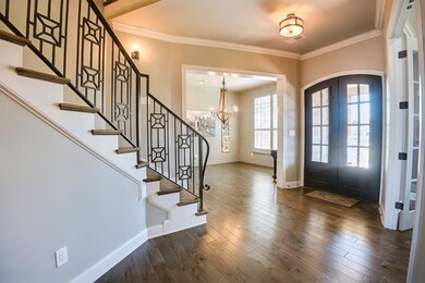 Entryway featuring crown molding, baseboards, and 