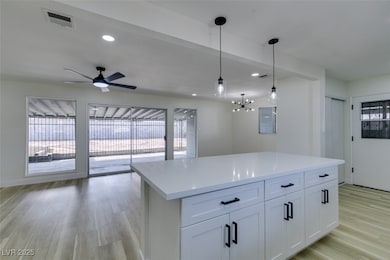 Kitchen with light wood-style flooring, visible ve