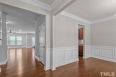 Entrance foyer and formal dining decorated with ch