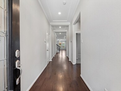 Wood floors extend through downstairs common areas