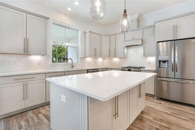 Tiled back splash, quartz counters, under cabinet