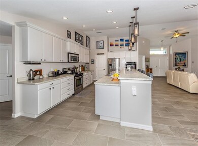 Kitchen has vaulted ceilings and clean white moder