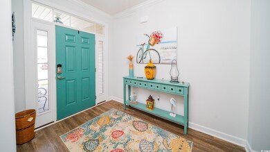 Entrance foyer featuring crown molding, baseboards