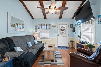 Living room featuring vaulted ceiling with beams, 