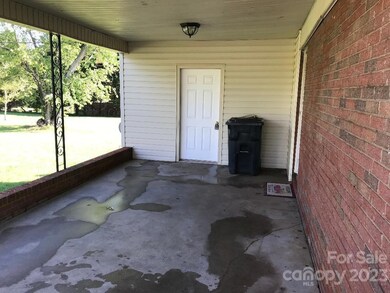 CARPORT freshly pressure-washed carport with large utility room for extra storage
