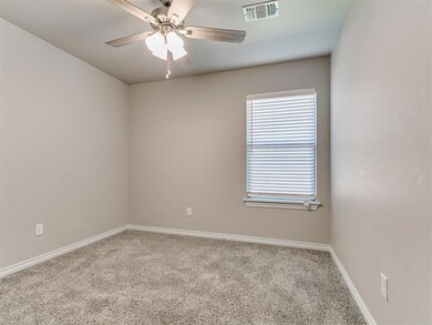 Empty room with carpet flooring, a ceiling fan, and baseboards